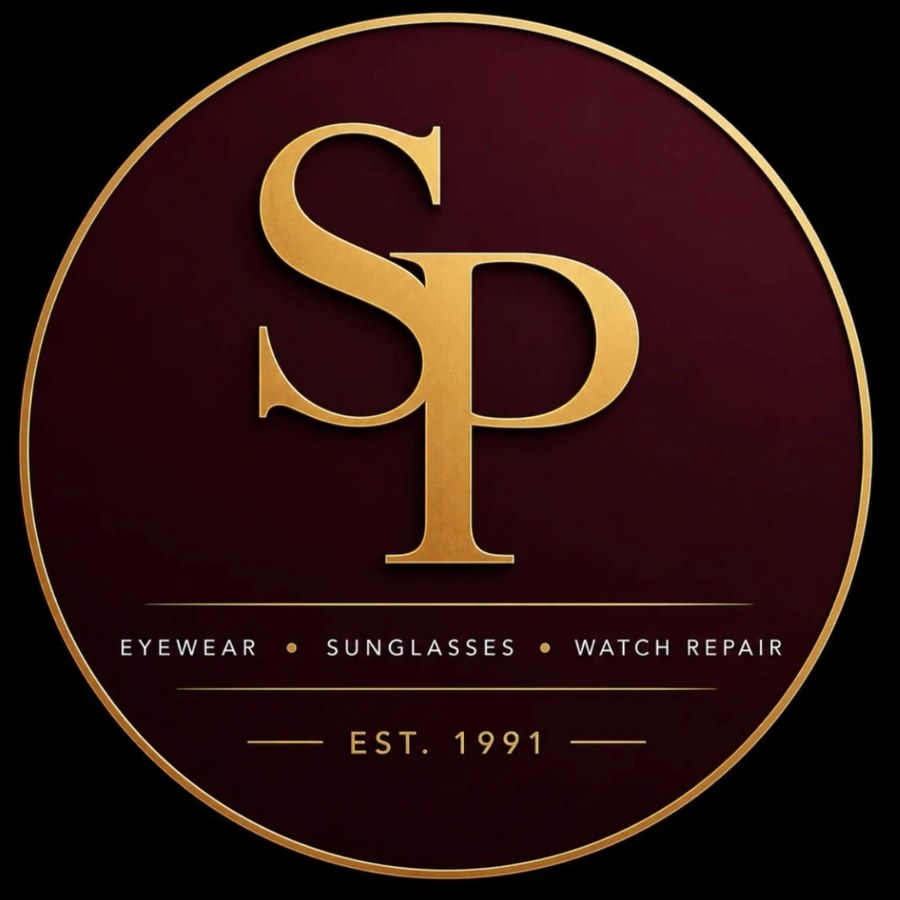 The Sunglass Plus seal — gold SP monogram on a deep burgundy field inside a gold ring